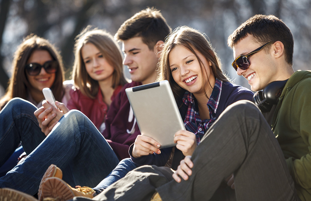 Young and happy urban people having fun with digital tablet